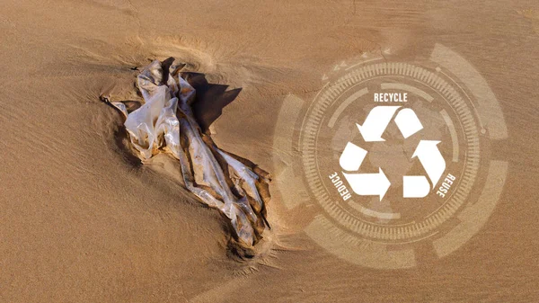 Plastik torba üzerindeki küçültme, yeniden kullanma, geri dönüşüm sembolü plajda atık doğayı kirleten, ekolojik atık yönetimi ve sürdürülebilir ve ekonomik yaşam tarzı için ekolojik metafor olarak bırakılır..