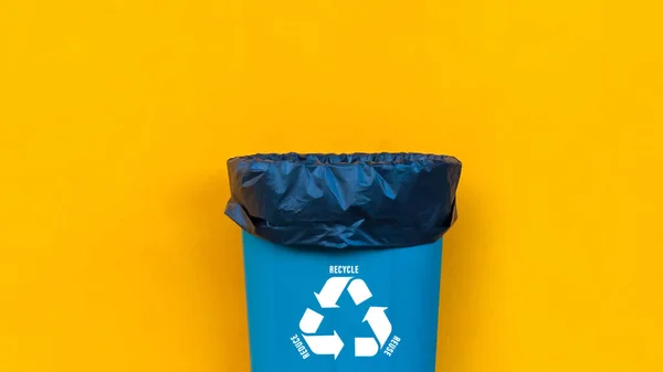 Reduce, reuse, recycle symbol with garbage bin on yellow background, Ecological concept, ecological metaphor for ecological waste management and sustainable and economical lifestyle.