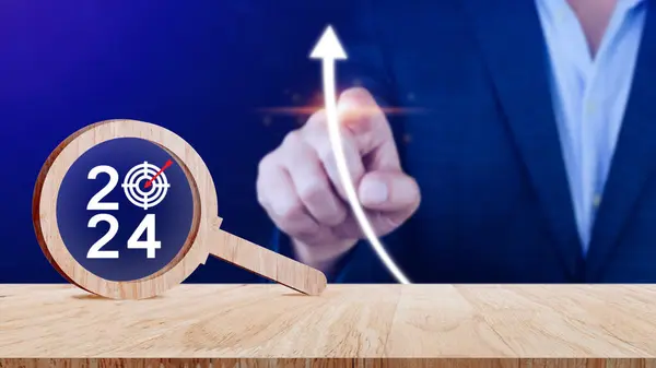 Happy new year 2024 with business concept banner,  2024 year number with Target icon inside the wooden magnifying glass on wooden table background, Planning for goal and success concepts.