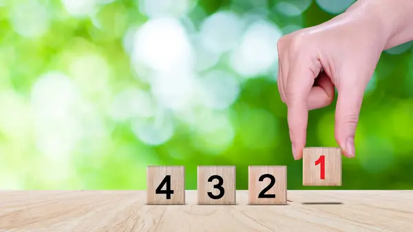 Task priority and management concept, The order of priority in any activity, Set work priority, arrange to do list. Hand arranging Wooden cube blocks with number first, second, third.