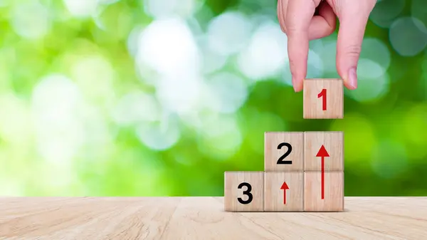 Task priority and management concept, The order of priority in any activity, Set work priority, arrange to do list. Hand arranging Wooden cube blocks with number first, second, third.