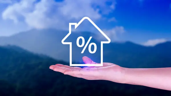 Real estate property investment concept, Asset management, Interest rates, inflation, loan mortgage, increase tax. Hand holding house icon with percent.