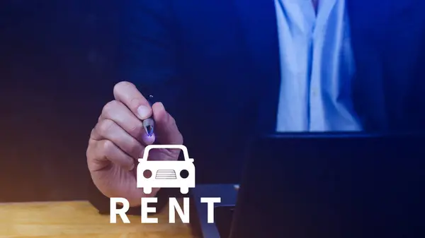 Vehicle, transportation investment and car mortgage financial concept, Realtor\'s hand puts with icon car and word RENT. Rent a car.