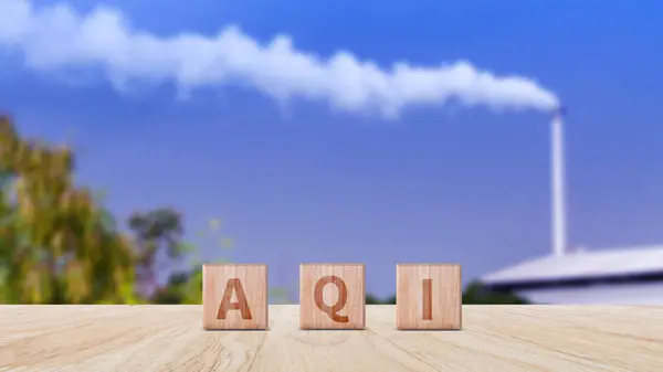 AQI, Abbreviation of air quality index word written on wooden blocks. text AQI on nature background, environment concept.