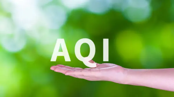 AQI, Abbreviation of air quality index, hand holding AQI on nature background, environment concept.