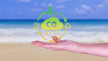 Hand holding CO2 reducing virtual icon for decrease carbon dioxide emission, carbon footprint and carbon credit to limit global warming from Bio climate change concept. clipart