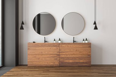 Beyaz ve gri duvarlı modern banyonun köşesi, ahşap zemin, çift lavabo ve iki yuvarlak ayna. Bulanık görüşlü bir pencere. 3d oluşturma