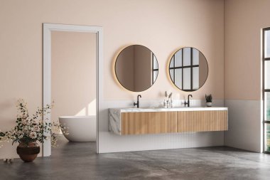 Modern banyo, beyaz fayanslar, bej duvarlar, beton zemin, mermer tezgahta çift beyaz lavabo, üzerinde oval aynalar ve rahat beyaz küvet. 3d oluşturma