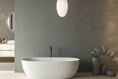 Çift lavabolu ve oval aynalı modern gri banyo, küvet, vazoda kuru bitkiler, granit zeminde halı. Otel stüdyosunda banyo aksesuarları ve pencere. 3B görüntüleme