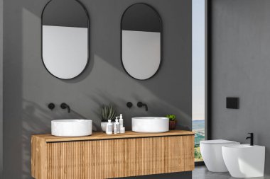 Çift lavabo, gri duvarda oval aynalar, minimalist banyoda siyah musluklar olan ahşap bir dolap. Yan görüş. 3d oluşturma