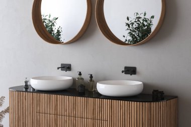 Çift lavabo, beyaz duvarda oval aynalar, minimalist banyoda siyah musluklar olan ahşap bir dolap. Ön manzara. 3d oluşturma