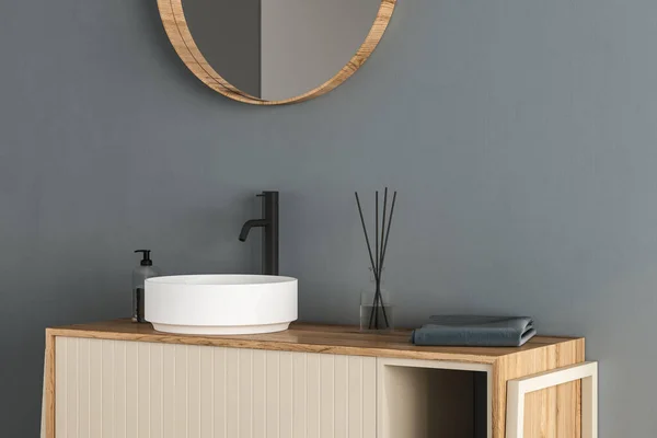 白い壁に立って楕円形の鏡と白いシンクの閉じる ミニマリストのバスルームで黒い蛇口と木製のキャビネット モックアップは 製品の表示の略です 3Dレンダリング — ストック写真
