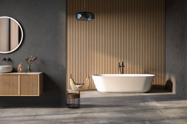 Konforlu küvet ve banyo havuzu modern banyoda duruyor. Mavi, ahşap duvarlar ve beton zemin. Ön manzara.