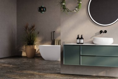 modern banyo bej ve toprak renkli duvarlar, beyaz küvet, yeşil kibir, siyah ayna, lavabo, terrazzo zemin ve pencereden deniz manzarası.