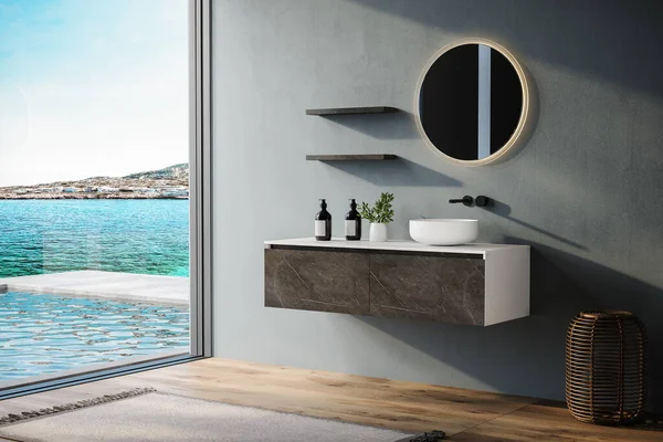 Minimal bathroom with blue tones walls, marble and white vanity, oval mirror, sink, parquet floor, and a view of the pool and sea from the window