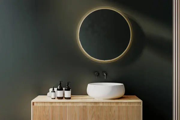 Close up of sink with oval mirror standing in on green wall , wooden vanity with black faucet in minimalist bathroom. Side view. 3d rendering
