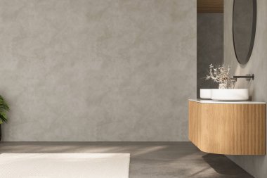 Lavabosu ve aynası olan bir banyo. Banyo boş ve modern bir görünüşü var.