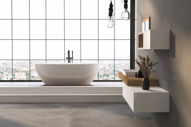 Büyük pencereli ve beyaz küvetli bir banyo. Banyo temiz ve iyi ışıklandırılmış, rafında bir vazo çiçek var. Manzara sakin ve rahatlatıcı.