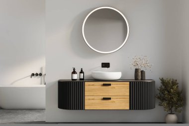 Ahşap ve siyah panelli şık banyo kibri, yuvarlak ışıklı ayna ve doğal dekorla tamamlanmış modern gemi lavabosu. 3B görüntüleme