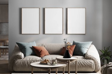 Bej renkli peluş bir kanepesi, dekoratif yastıkları, yuva yapan sehpaları ve boş çerçeveleri olan modern oturma odası nötr bir duvarda, minimalist bir mutfağa bitişik. 3B görüntüleme