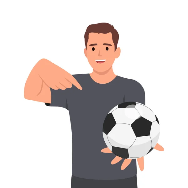 若い男はサッカーボールで手を握り 指を指差した 白い背景に隔離された平らなベクトル図 — ストックベクタ