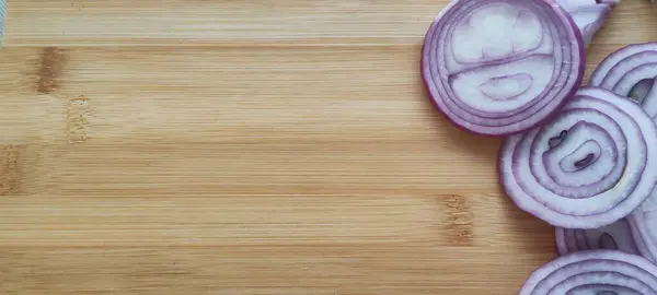Purple onion chopped into rings. Beautiful presentation photo on blackboard.