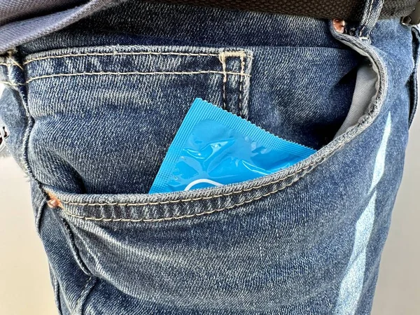 Man Puts New Condom Blue Package His Jeans Pocket Intimacy — Stock Photo, Image