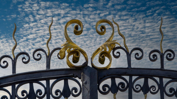 forged fence on the sky background