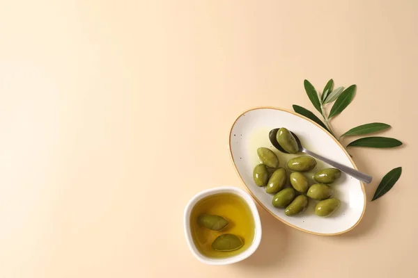 olive oil with olives on a green plate on white background. top view. copy space