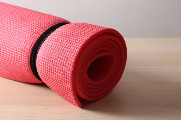 red yoga mat on the floor, closeup. yoga equipment