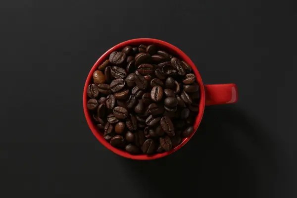 red coffee cup on a black background.