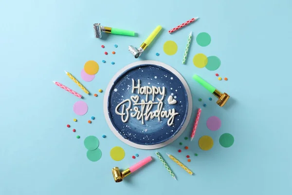 birthday concept. blue birthday candles, cake and gift on a blue background