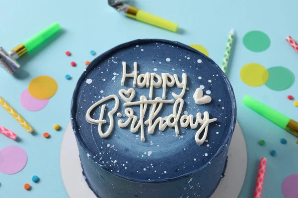 happy birthday cake on white table with colorful candles. top view with space for your text