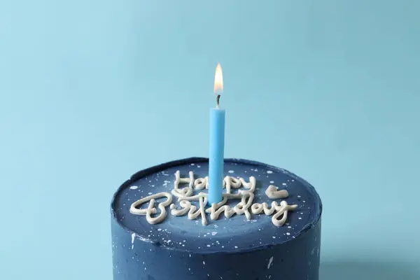 candle on the blue background. birthday cake with candle.