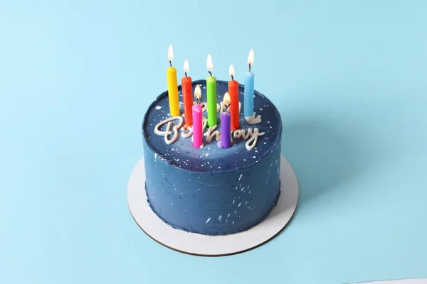happy birthday with candles and blue background.