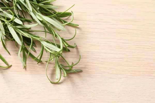 rosemary herb and rosemary on wooden background