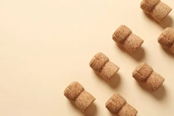 Corks of champagne over a colored background.