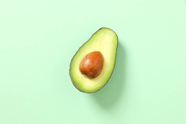 Green avocado on a colored background