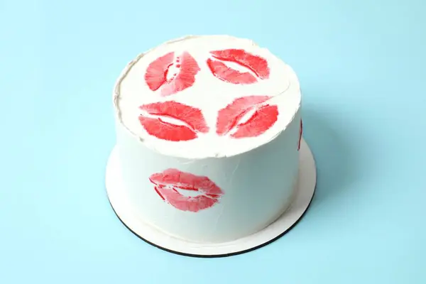 Colorful cake decorated with red lips on a colored background