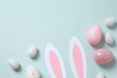 Paskalya dekoru konsepti. Paskalya tavşanı kulakları, çeşitli yumurtalar ve renkli arka planda Paskalya dekoru. 