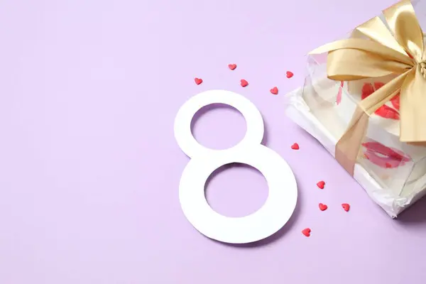 Number 8 and colorful cake decorated with red lips on a colored background