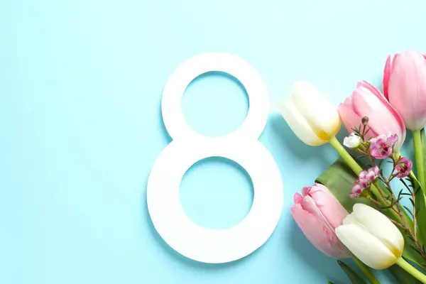 Number eight with beautiful tulips on color background