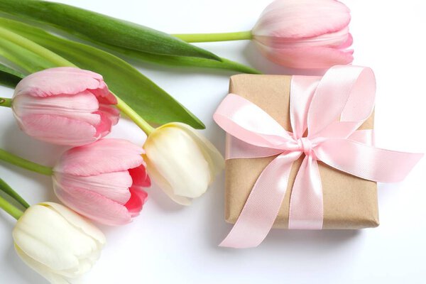 Beautiful tulips with a giftbox on white background