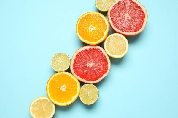 Tropical fruits on a colored background. Summer concept. Flat lay, top view, copy space