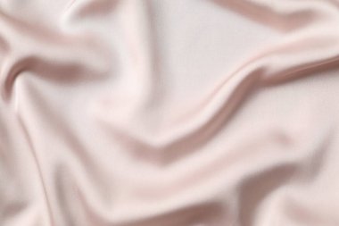 Bej ipek saten. Parlak pürüzsüz kumaş. Yumuşak kıvrımlar. Tasarım için alanı olan lüks arkaplan. 