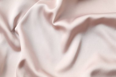 Bej ipek saten. Parlak pürüzsüz kumaş. Yumuşak kıvrımlar. Tasarım için alanı olan lüks arkaplan. 