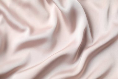 Bej ipek saten. Parlak pürüzsüz kumaş. Yumuşak kıvrımlar. Tasarım için alanı olan lüks arkaplan. 