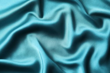 Bej ipek saten. Parlak pürüzsüz kumaş. Yumuşak kıvrımlar. Tasarım için alanı olan lüks bir arka plan. Düz masa, üst görünüm