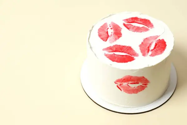 Colorful cake decorated with red lips on color background