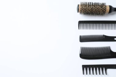 Beyaz arka planda profesyonel tarak ve kuaför araçları, üst görünüm